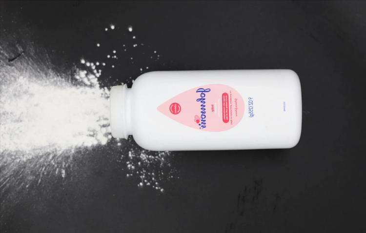 Talcum powder pouring onto a surface linked to ovarian cancer lawsuit and settlement claims.