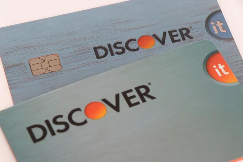 Two Discover credit cards representing merchant fee misclassification claims in $1.2B settlement